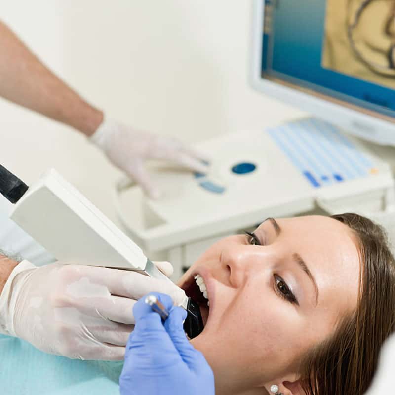 Patient being treated with digital intraoral scanner